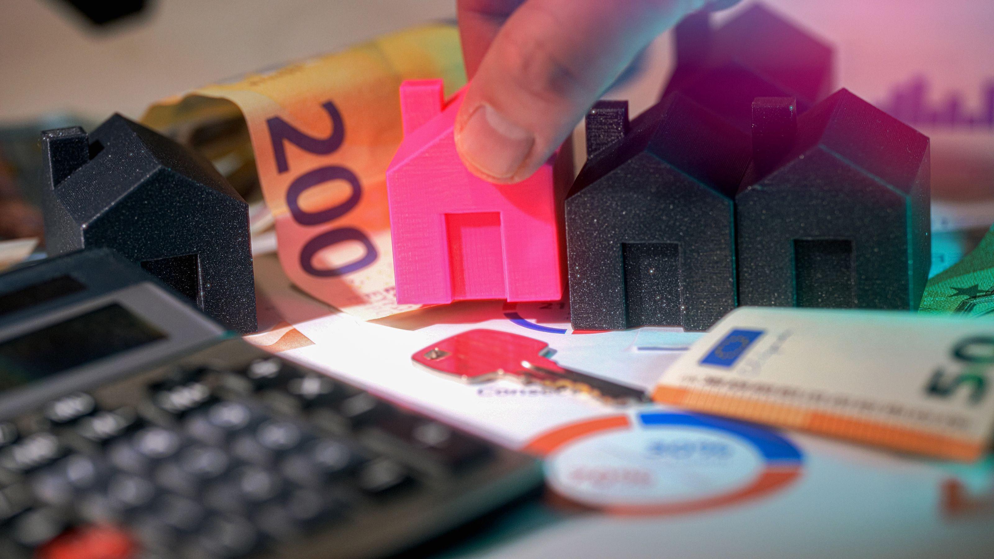 Home refinancing concept with houses, mortgage documents, calculator and money showing potential savings for homeowners.