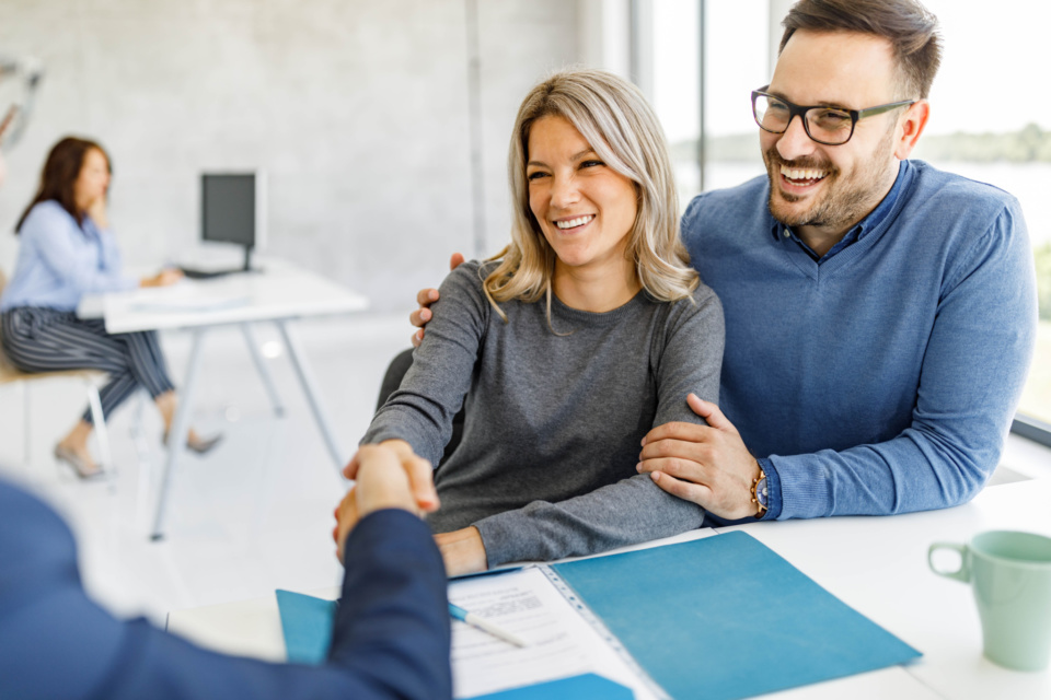 Happy couple came to an agreement with their financial advisor in the office 1254014334 3869x2579