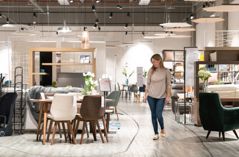 Happy woman shopping at a furniture store 1046843180 2140x1405