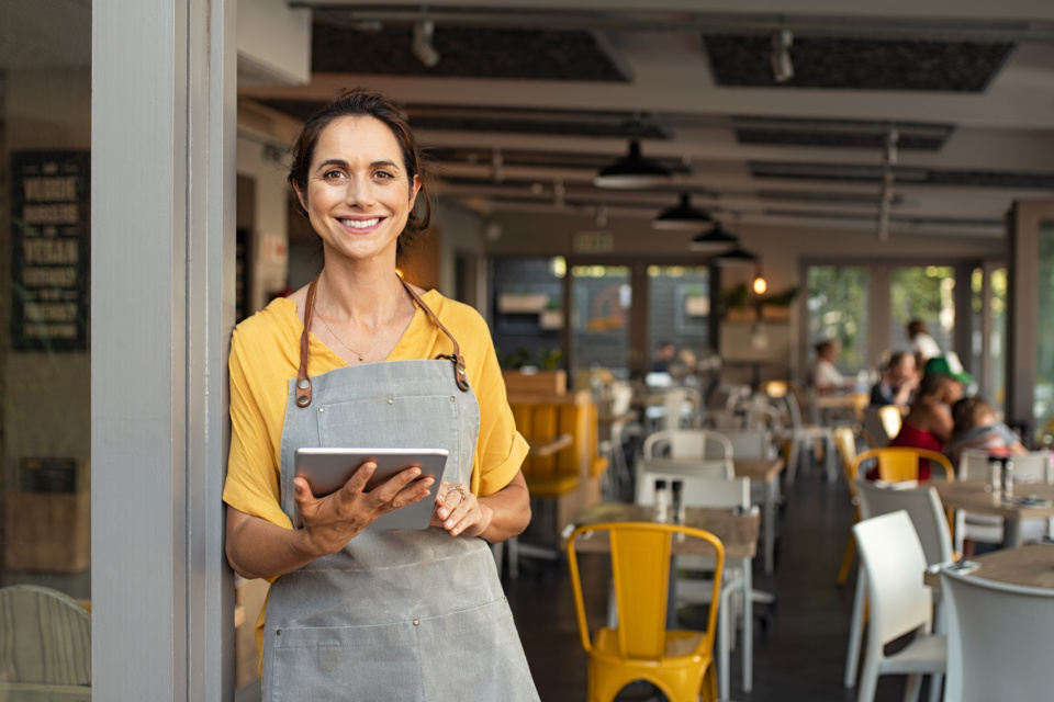 Small business owner at entrance looking at camera 1180926063 2124x1415