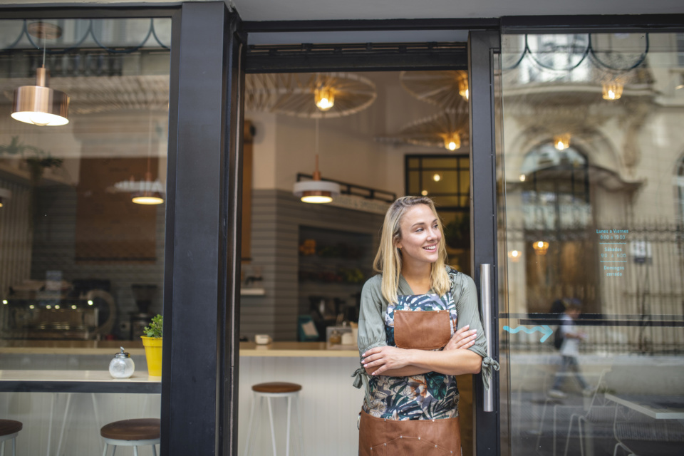 Young Cafe Owner Standing with Arms Crossed at Front Door 1191194146 2125x1417